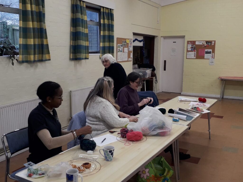 The ladies of art club making pom pom's
